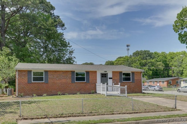 single story home featuring a front lawn, central AC, brick siding, and a fenced front yard