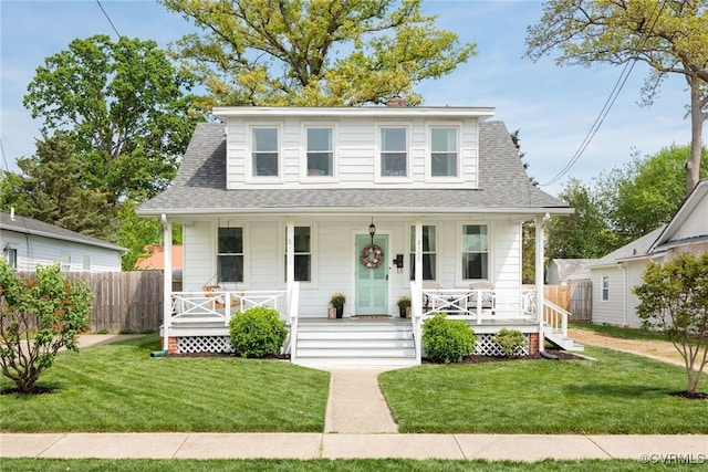 bungalow-style house featuring fence, a porch, a front yard, and roof with shingles