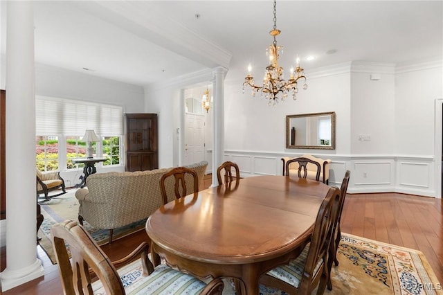 9522 Nassington Ct, Henrico, VA 23229 - dining area with hardwood / wood-style flooring, crown molding, a chandelier, wainscoting, and a decorative wall