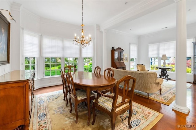 9522 Nassington Ct, Henrico, VA 23229 - dining space with ornate columns, light wood finished floors, a chandelier, and crown molding