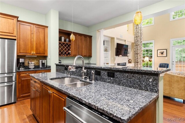 9522 Nassington Ct, Henrico, VA 23229 - kitchen featuring appliances with stainless steel finishes, a sink, light wood-type flooring, and open floor plan