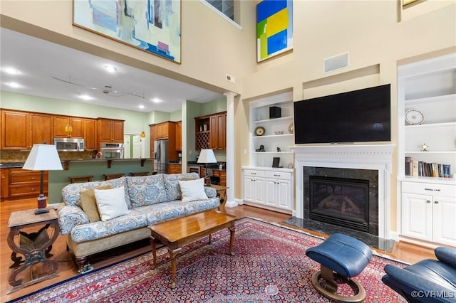 9522 Nassington Ct, Henrico, VA 23229 - living area with built in shelves, a fireplace, and a towering ceiling