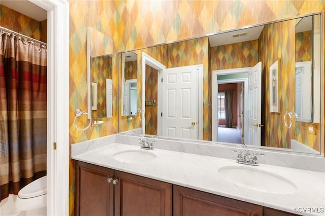9522 Nassington Ct, Henrico, VA 23229 - bathroom with wallpapered walls, double vanity, and toilet