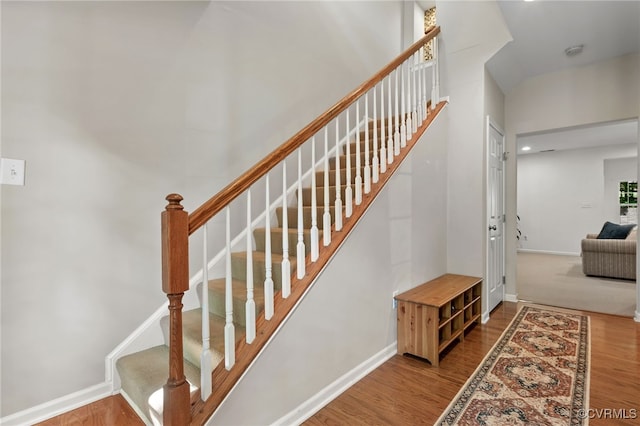stairs with baseboards and wood finished floors