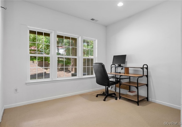 carpeted office space featuring recessed lighting, baseboards, visible vents, and plenty of natural light