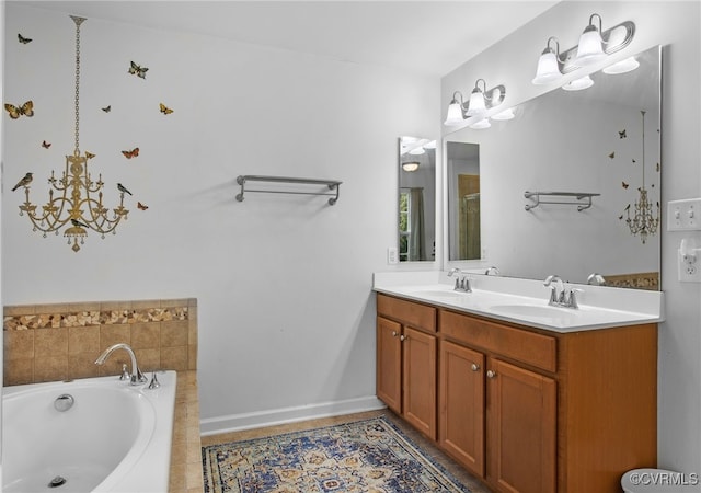 bathroom featuring a sink, baseboards, double vanity, and a bath