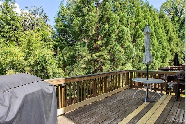 wooden deck with a grill