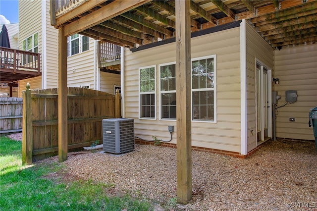 exterior space featuring central air condition unit and fence