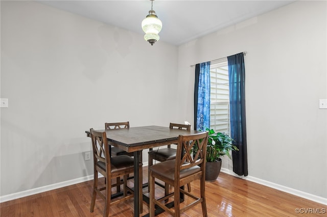 dining room featuring baseboards and wood finished floors