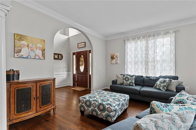 living area with ornamental molding, arched walkways, wainscoting, and dark wood-type flooring