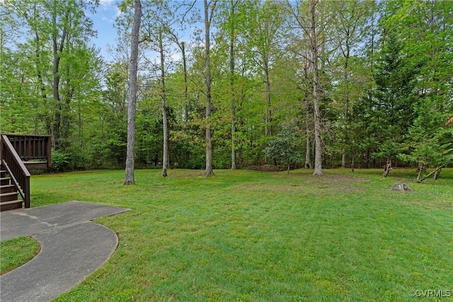 view of yard featuring a wooden deck and stairway