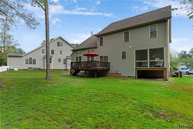 rear view of property with a lawn, a deck, crawl space, and a sunroom