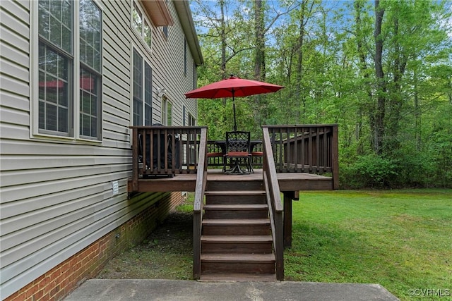 wooden terrace with a lawn