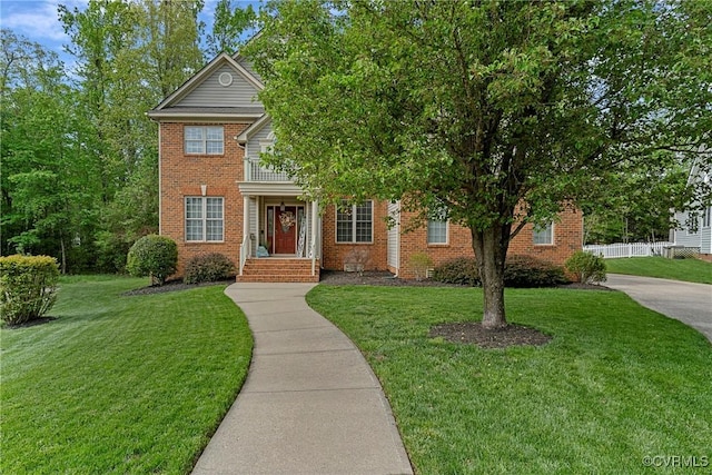 view of front of property with a front lawn and brick siding