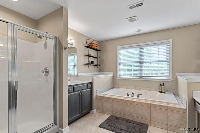 bathroom with vanity, visible vents, a shower stall, and tile patterned floors