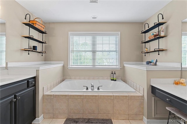 full bath featuring a bath, tile patterned floors, and vanity