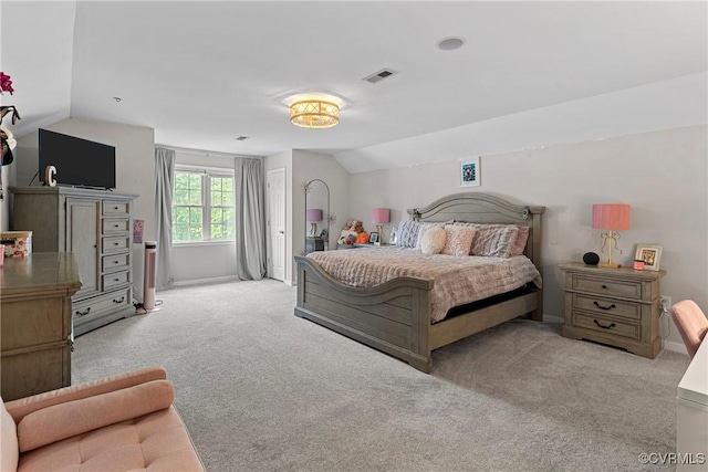bedroom featuring visible vents, vaulted ceiling, and carpet floors