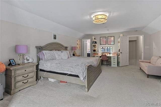 bedroom with light colored carpet and vaulted ceiling