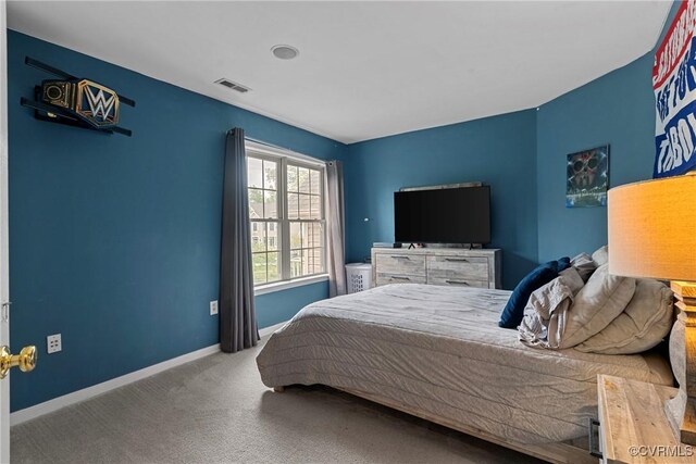 carpeted bedroom featuring visible vents and baseboards