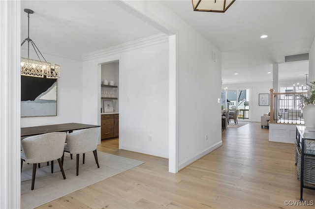interior space with recessed lighting, an inviting chandelier, light wood-style flooring, baseboards, and crown molding
