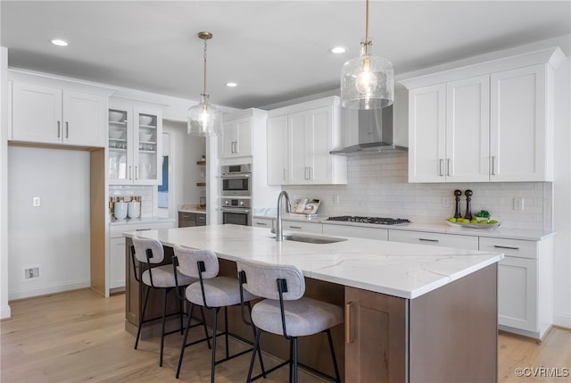 kitchen featuring white cabinets, stainless steel appliances, backsplash, and a sink