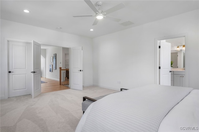 bedroom with recessed lighting, visible vents, light carpet, and baseboards