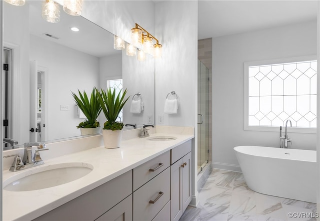 full bathroom with a stall shower, marble finish floor, a sink, and visible vents