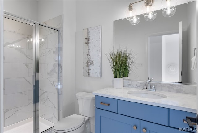 bathroom with a marble finish shower, toilet, and vanity