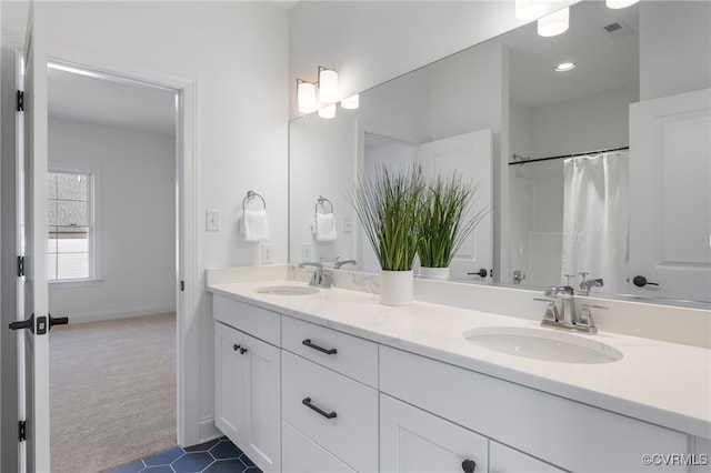 full bathroom with tile patterned floors, visible vents, double vanity, and a sink