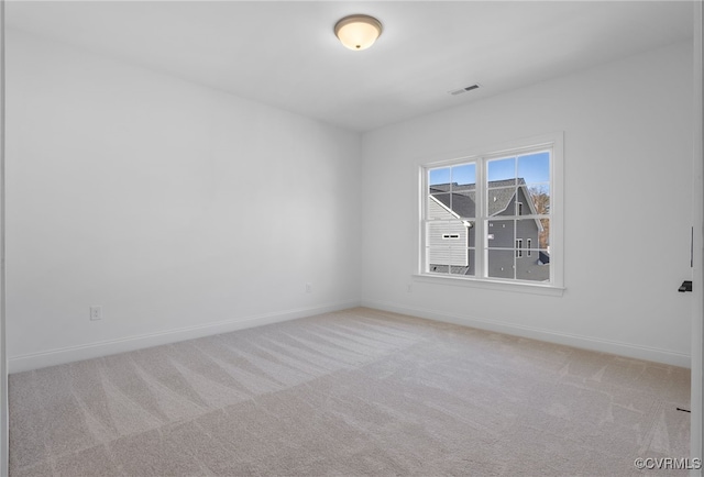empty room with visible vents, carpet, and baseboards