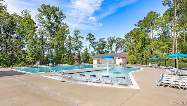 pool with fence and a patio area