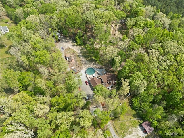 birds eye view of property with a wooded view