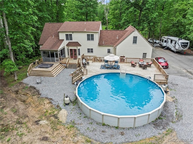 13032 Beech Creek Ln, Ashland, VA 23005 - outdoor pool with a deck, a forest view, a sunroom, and outdoor dining space