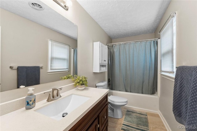 bathroom with tile patterned floors, a wealth of natural light, toilet, and vanity