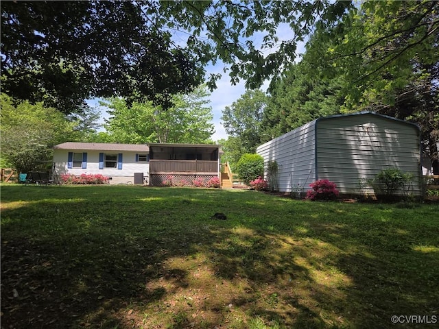 116 Sycamore Ct, Bracey, VA 23919 - view of yard featuring an outdoor structure, a sunroom, and a storage shed