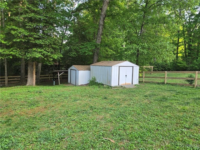 116 Sycamore Ct, Bracey, VA 23919 - view of yard featuring fence, a storage unit, and an outbuilding