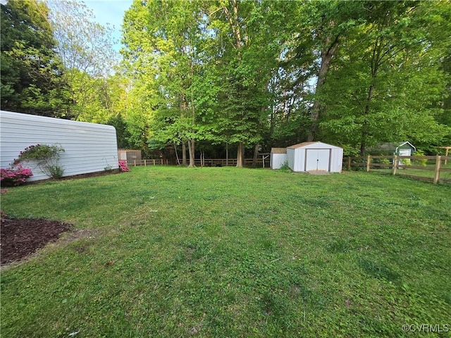 116 Sycamore Ct, Bracey, VA 23919 - view of yard featuring a storage unit, an outbuilding, and a fenced backyard