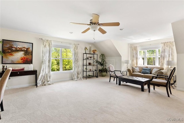 sitting room featuring carpet flooring, baseboards, plenty of natural light, and ceiling fan