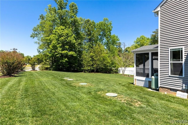 view of yard with fence and a sunroom