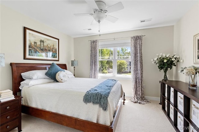 carpeted bedroom with visible vents, a ceiling fan, and baseboards