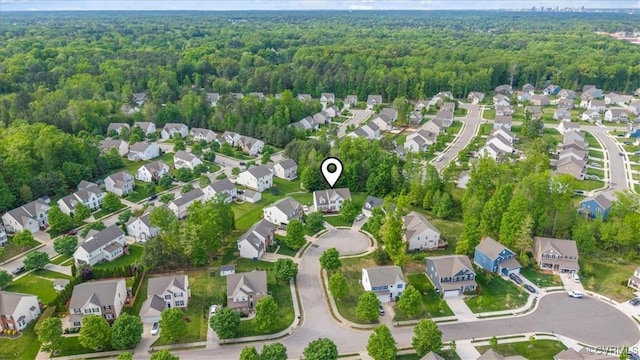 birds eye view of property with a wooded view and a residential view