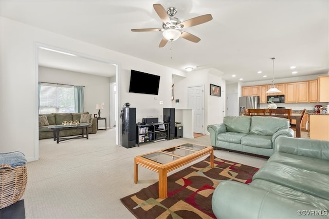 living area featuring baseboards, recessed lighting, a ceiling fan, and light colored carpet