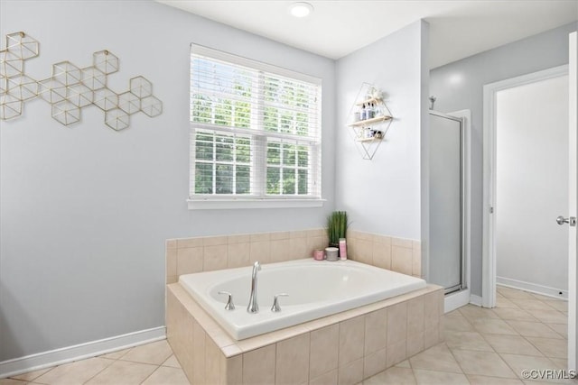 full bathroom with tile patterned floors, baseboards, a stall shower, and a garden tub