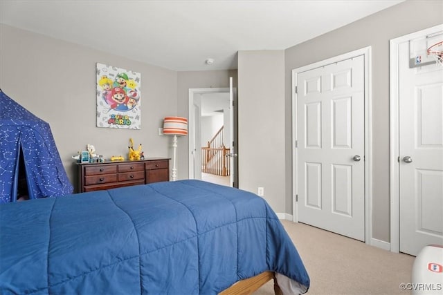 bedroom with carpet floors and baseboards