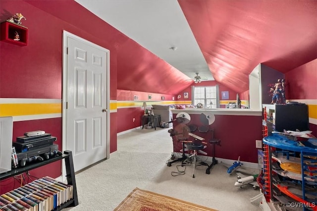 interior space featuring ceiling fan, vaulted ceiling, carpet floors, and baseboards