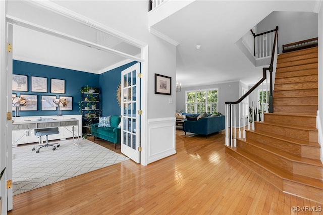 home office featuring crown molding, wainscoting, and hardwood / wood-style floors