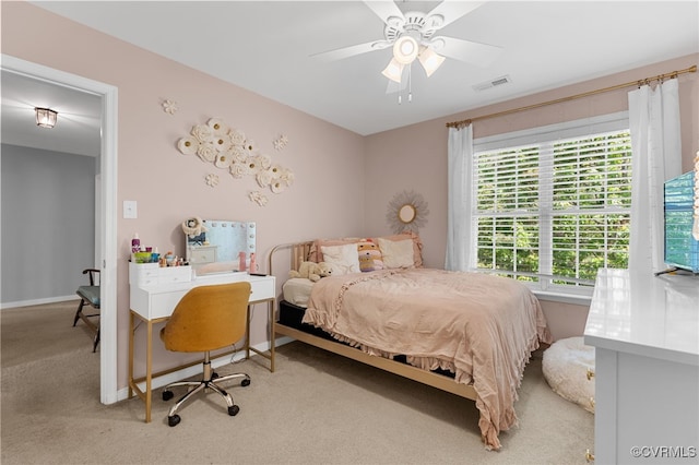 carpeted bedroom with a ceiling fan, baseboards, and visible vents
