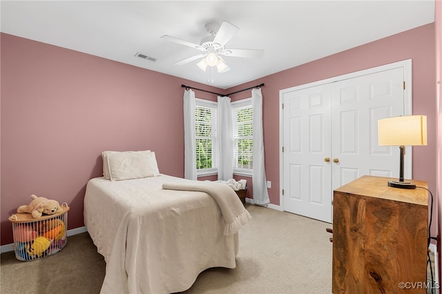 bedroom with baseboards, ceiling fan, light carpet, and visible vents