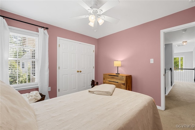 bedroom featuring ceiling fan, carpet floors, baseboards, visible vents, and a closet
