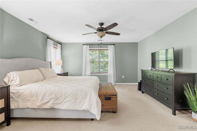 carpeted bedroom featuring a ceiling fan, baseboards, and visible vents